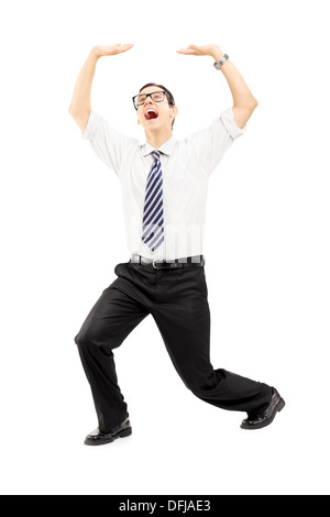 Full length portrait of a scared young man protecting from above with his hands Stock Photo