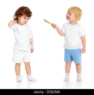 Baby boy with paint brush and girl standing full length isolated on white background Stock Photo