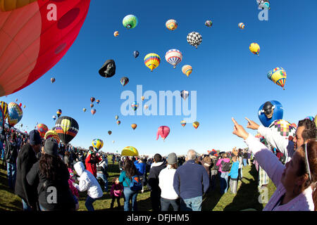 Albuquerque, NM, USA. 5th Oct, 2013. . Spectators point to a variety of balloons in the sky, First day of mass ascension at Albuquerque International Balloon Fiesta on Saturday October 3, 2013. Albuquerque, New Mexico, USA. Credit:  Christina Kennedy/Alamy Live News Stock Photo