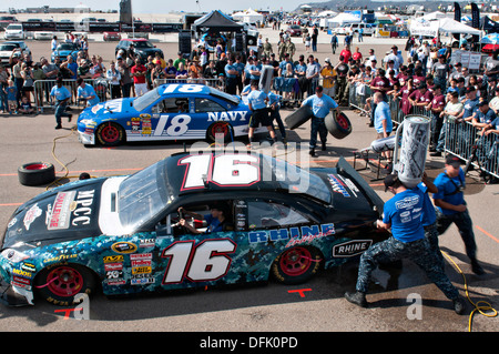 US Navy Sailors compete during the Military Pit Crew Challenge at the 16th Annual NASCAR Coronado Speed Festival September 21, 2013 in San Diego, CA. The event was held as a part of San Diego Fleet Week to help promote partnership between military and local communities. Stock Photo