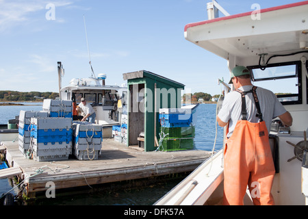 Lobsterman Eric Emmons departs lobster dock after purchasing additional lobsters for his clients. ME Maine New England Stock Photo