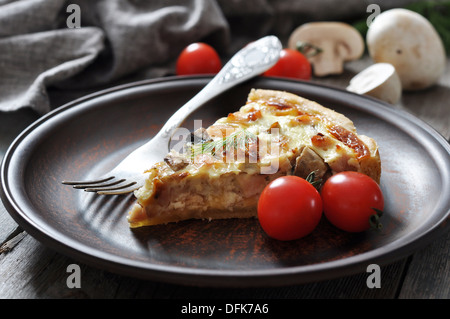 Traditional french quiche pie with chicken and mushrooms on a wooden background  Stock Photo