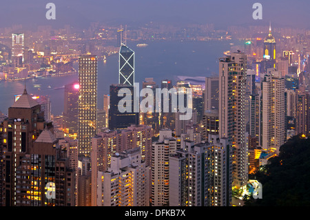 Night view over the skyscrapers in Central District and across the Victoria Harbour to Kowloon, Hong Kong Stock Photo
