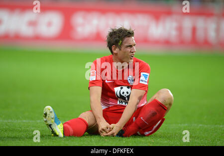 Freiburg, Germany. 06th Oct, 2013. Freiburg's Oliver Sorg sits on the pitch during the German Bundesliga soccer match between SC Freiburg and Eintracht Frankfurt at Mage Solar Stadium in Freiburg, Germany, 06 October 2013. Photo: PATRICK SEEGER/dpa/Alamy Live News Stock Photo