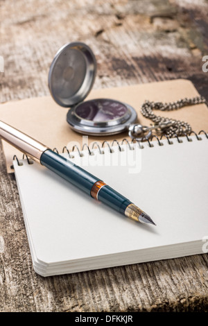 Blank Pocketbook with ink pen and old pocket watch Stock Photo