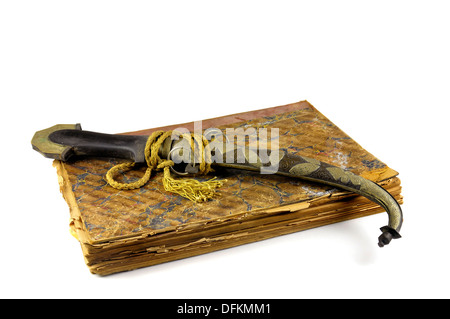 Arab dagger and very old book isolated in white Stock Photo