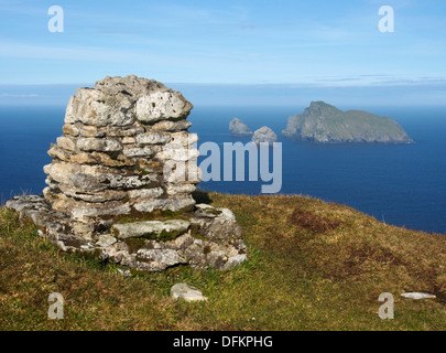 Trig point on summit of Conachair, Hirta, St Kilda, with Boreray and the Stacs behind Stock Photo