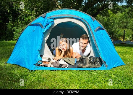 Portrait of a young couple lying in a tent Stock Photo