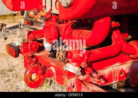 FIREFIGHTER AT THE BACK OF A RESCUE PUMP FIRE ENGINE AT A NIGHTTIME