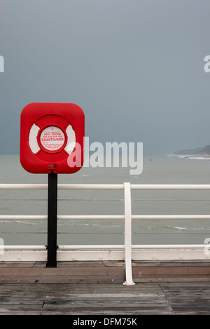 A lifebouy on Cromer Pier Norfolk UK in overcast light with strong saturated red colours Stock Photo