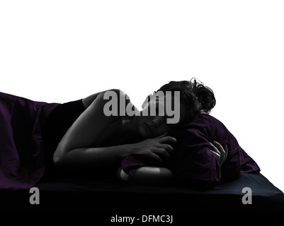 one woman in bed sleeping alarm clock silhouette studio on white background Stock Photo