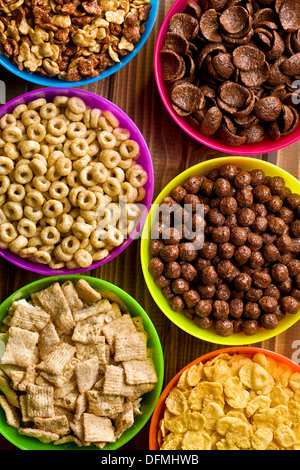 top view of various kids cereals in plastic bowls Stock Photo