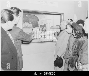 Photograph of a group of unidentified dignitaries in the Lincoln Museum at Ford's Theater, examining an exhibit... 199496 Stock Photo