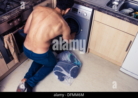 Young man doing laundry Stock Photo