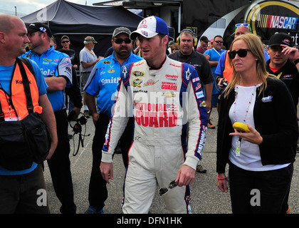 Dale Earnhardt, Jr., driver of the No. 88 National Guard Chevy, walks to the media interview area following his qualifying run for the AAA 400 Sept. 27, 2013, at Dover International Speedway in Dover, Del. Earnhardt earned the pole position, setting a new Stock Photo