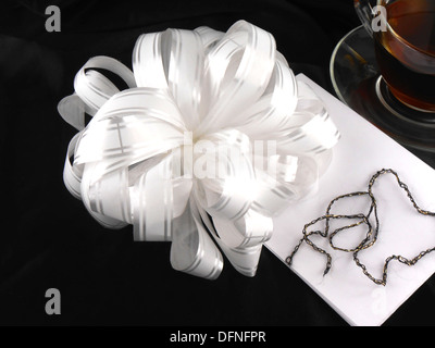 hot cup of tea with gift bow ribbon Stock Photo