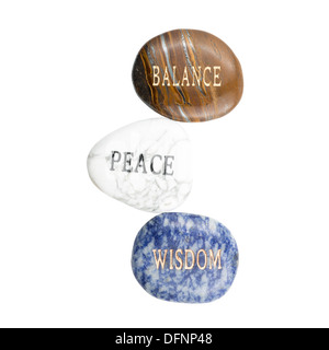 Stones with the words Balance (Polished Tiger Iron), Peace (Howlite), and Wisdom (sodalite). Cut out on white background Stock Photo