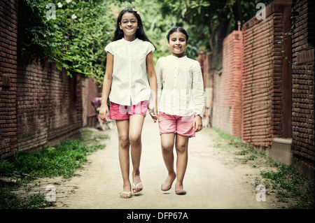 Two girls walking on the street, An Indian rural scene Stock Photo - Alamy