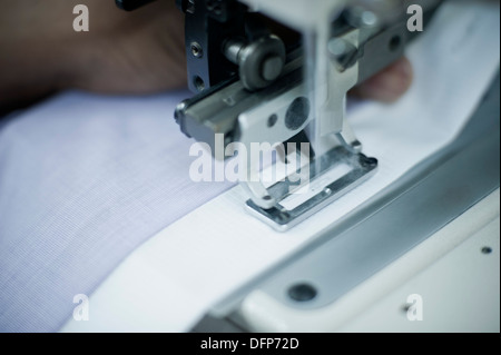 Cloth being stitched on the sewing machine Stock Photo