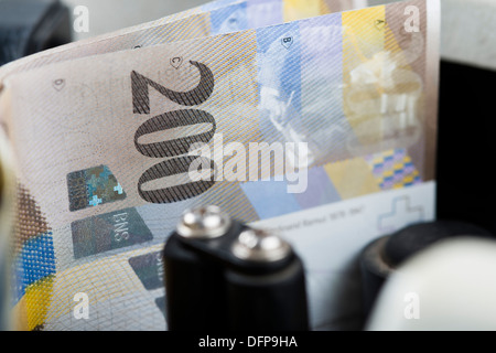 Two Hundred Euro notes being counted in a machine Stock Photo