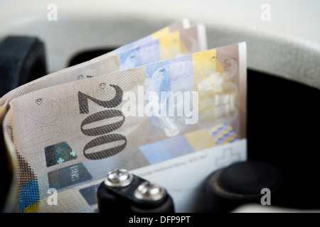 Two Hundred Euro notes being counted in a machine Stock Photo