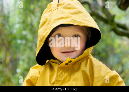 four years old girl in a yellow raincoat Stock Photo