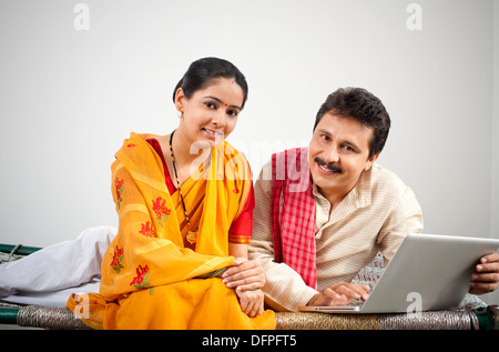 Portrait of a couple using a laptop Stock Photo