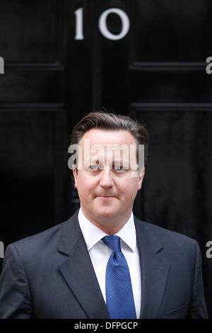 London, UK. 8th October 2013. British Prime Minister David Cameron leaves No.10 Downing Street to greet Herman Van Rompuy President of the European Council in London, Britain, 08 October 2013. Stock Photo