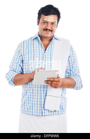 South Indian man using a digital tablet Stock Photo