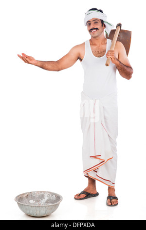 Portrait of a farmer carrying spade o his shoulders and gesturing Stock Photo