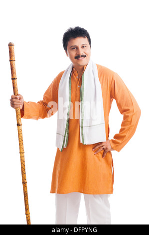 Portrait of a man holding wooden staff and smiling Stock Photo