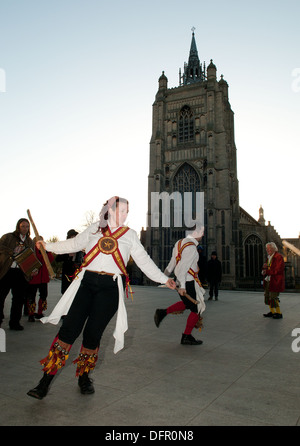 Traditional English Morris Dancers perform outside the church of St. Peter Mancroft in Norwich at dawn on May Day. Stock Photo