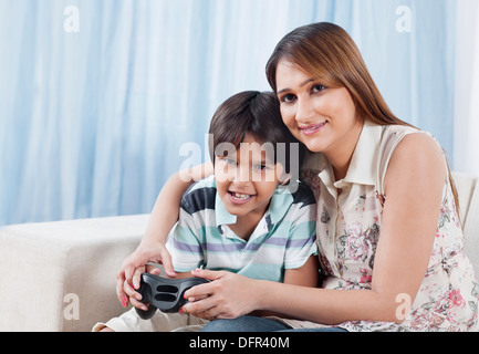 Woman playing video game with her son Stock Photo