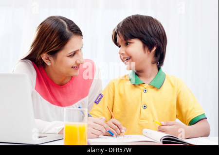 Woman assisting her son in drawing Stock Photo