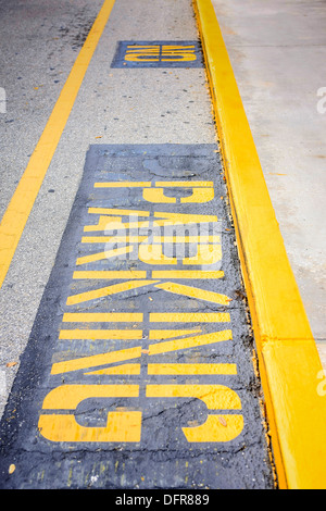 Yellow No Parking sign painted on the asphalt in a car park Stock Photo