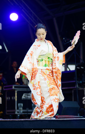Japanese female dancer wearing traditional costume of kimono performs on stage at a matsuri in London. Saturday 5th October 2013 Stock Photo