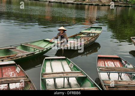 sightseeing boats docked on the Tam Coc River in Ninh Binh, Vietnam Stock Photo