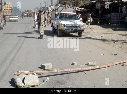 Security officials gather to measure extent of damages after hand grenade attack near a police station at Sariab Road of Quetta on Tuesday, October 08, 2013. A hand-grenade attack at Quetta's New Sariab police station on Tuesday wounded eight persons, including policemen, according to eye witnesses unknown motorcyclists hurled a hand grenade at the New Sariab police station situated on the outskirts of Quetta which exploded causing injuries to eight people. Stock Photo