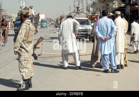 Security officials gather to measure extent of damages after hand grenade attack near a police station at Sariab Road of Quetta on Tuesday, October 08, 2013. A hand-grenade attack at Quetta's New Sariab police station on Tuesday wounded eight persons, including policemen, according to eye witnesses unknown motorcyclists hurled a hand grenade at the New Sariab police station situated on the outskirts of Quetta which exploded causing injuries to eight people. Stock Photo