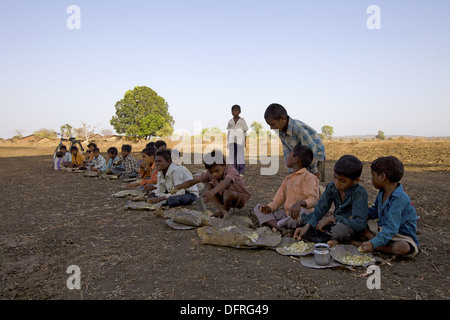 Children having lunch  in marriage ceremony of Korku Tribe, Khalwa, Jharikheda village, Madhya Pradesh, India. Stock Photo