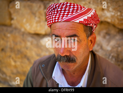 Kurdish men in traditional clothing sitting at a carpet shop in Qaysari ...