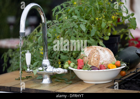 Bread and Tomato and Peppers in a Enamel Tin Bowl on a wooden Dinning Table Country Kitchen Stock Photo