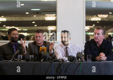 London, UK. 08th Oct, 2013. Dr. Usama Hassan, senior researcher in Islamic studies at the Quilliam Foundation (far Left) Stephen Yaxley-Lennon, AKA Tommy Robinson founder and leader of the anti-Islamist group,EDL (Centre Left) Maajid Nawaz (centre Right) and Kevin Carroll Co founder EDL (Far Right) at press conference where the English Defence League (EDL), pair announce decision to leave the group.  London, UK 2013-10-08 Credit:  martyn wheatley/Alamy Live News Stock Photo