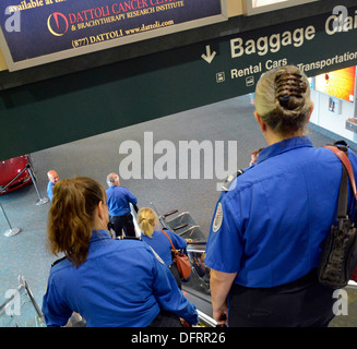 TSA agents desending escalator for shift change at Sarasota Bradenton International Airport, Sarasota, FL Stock Photo