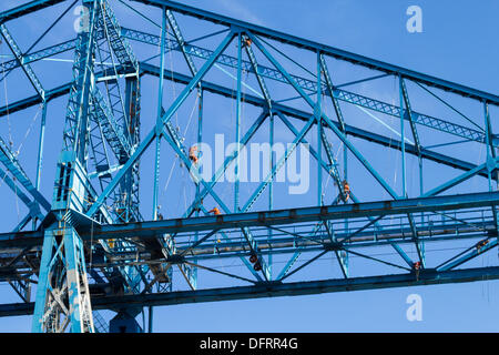 Middlesbrough, Cleveland, UK. 8th Oct, 2013. Workers continue painting The Transporter Bridge in Middlesbrough. The Gondola suspended from the bridge takes passengers and cars across the river Tees between Middlesbrough and Port Clarence. Painting started on 27th, August. It's ten years since the bridge was last painted. The Transporter Bridge is one of only three remaining Transporter Bridges in the UK; the other two are in Newport and Warrington. Credit:  ALANDAWSONPHOTOGRAPHY/Alamy Live News Stock Photo