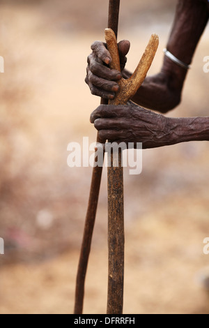 An elderly Rendille woman holding on to walking sticks near Laisamis, Kenya Stock Photo