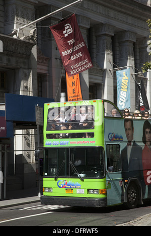 Tourist bus drives down Broadway at the Southern ti of Manhattan. Stock Photo