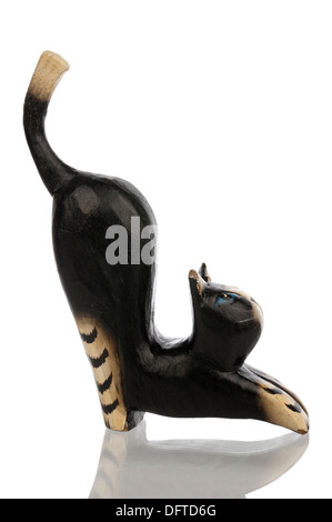 Wood carved black statuette of a kat from the right side isolated in white Stock Photo