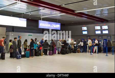 People queuing at the Ryanair check in and bag drop at Stansted Airport ...