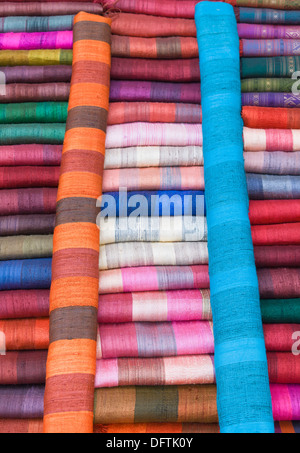 Colourful silk textiles on display at a market stall in Luang Prabang, Laos Stock Photo